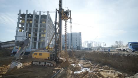 equipment for installing piles in ground, heavy machines for driving pillars work in laying the foundation building. construction aerial view height. construction site drilling pile foundation.