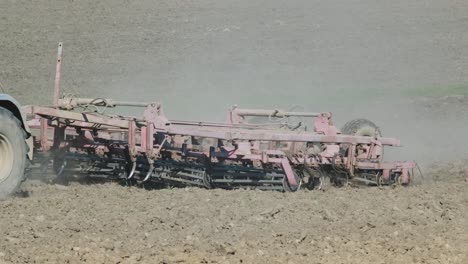 a tractor plowing dry agricultural field, preparing land for sowing. agricultural industry. processing the field in the farm.