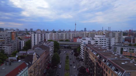 Smooth-aerial-top-view-flight-City-Berlin-suburban-railroad-station-prefabricated-building-skyscrapers-district-Neukoeln,-Germany-Summer-day-2023