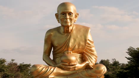 static view of a large golden monk statue