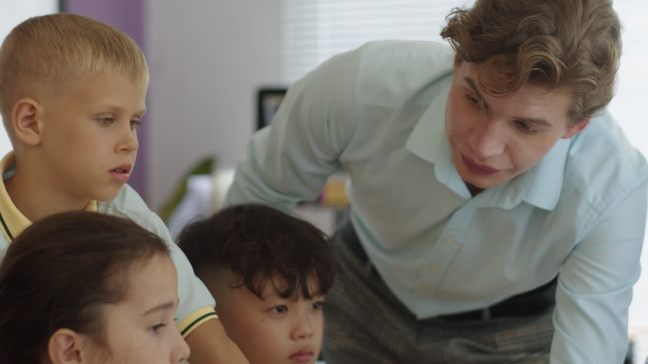 Tutor Teaching Elementary Pupils at School