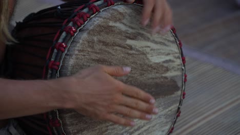 male hands playing bongo drums, close up
