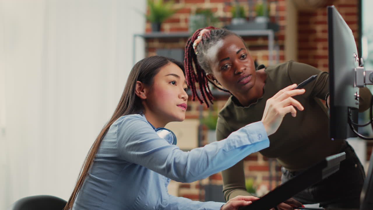 Female graphic designer editing photos with tablet and stylus