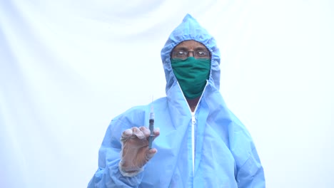 doctor in ppe kit blue protective suit, surgical mask latex gloves