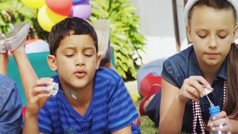 happy friends playing with bubble wand in backyard 4k