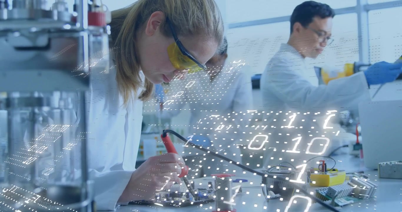 Woman applying solder on circuit in lab as binary data streaming while colleague adjusting meters