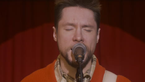 Close-Up-View-Of-The-Microphone-Against-Red-Curtain-On-Stage