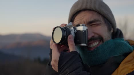 man with camera in the mountains