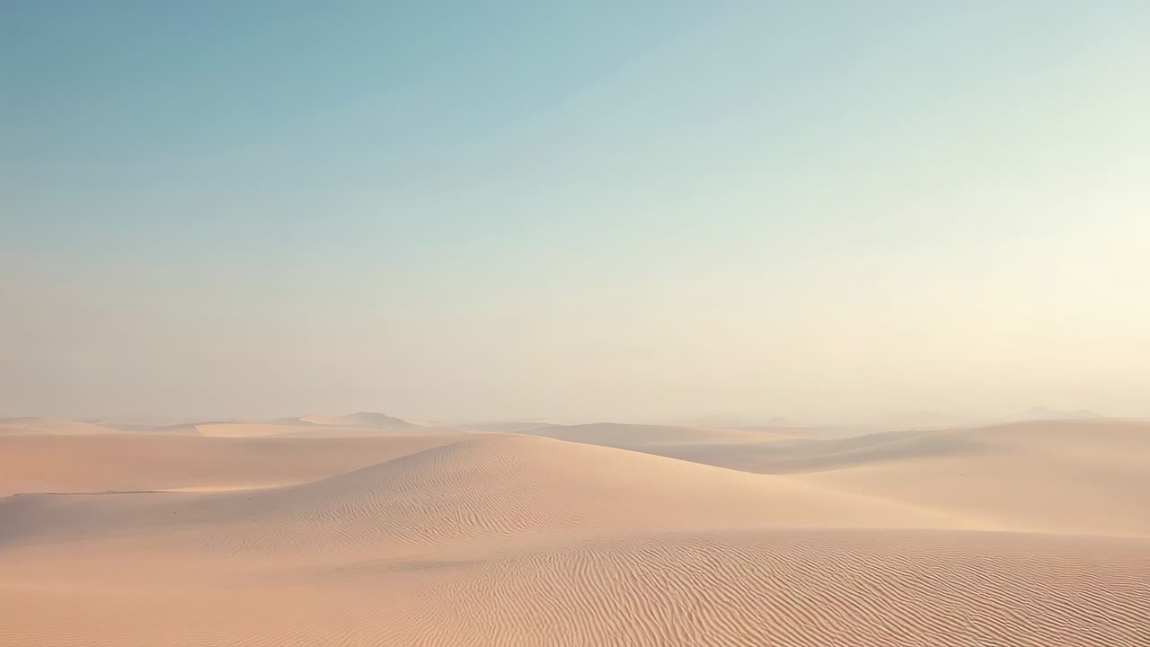 Moving camera slowly revealing foreground sand dune in sandy desert, showing ripple patterns