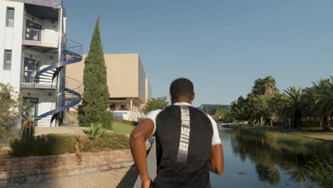 black runner man running and training for marathon outdoors