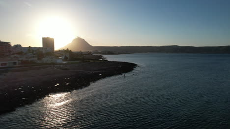 Aerial-Flying-Along-Coastline-Of-Javea-In-Alicante-During-Sunset-In-Late-Afternoon