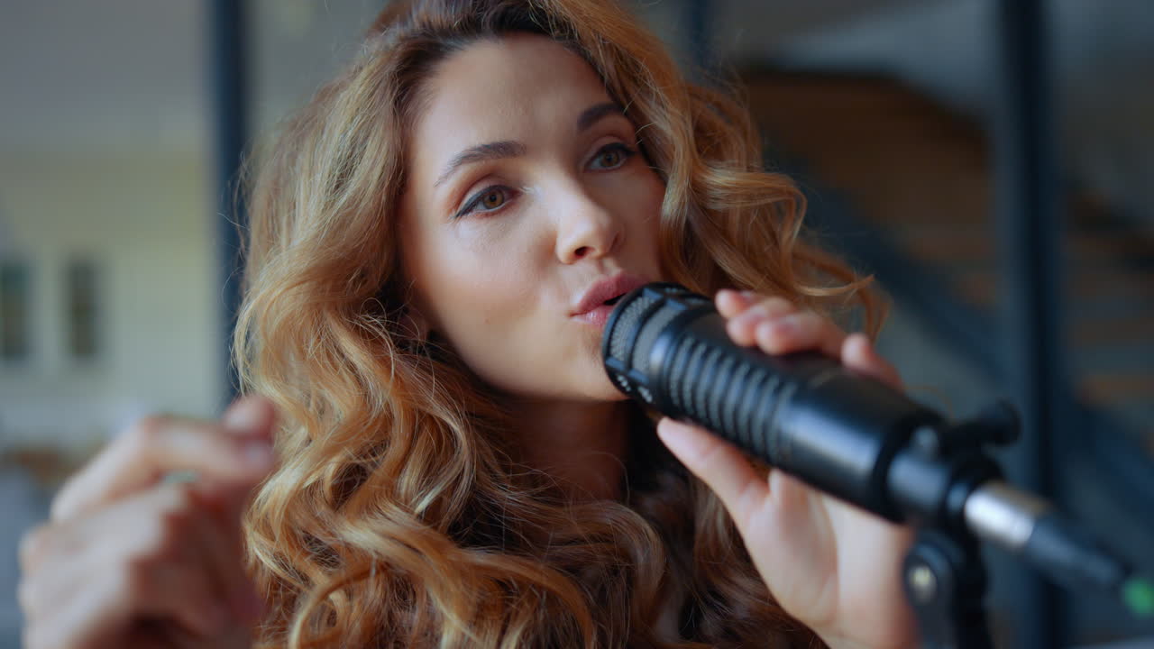 Woman singing in microphone. Musician snapping fingers in rhythm of the music
