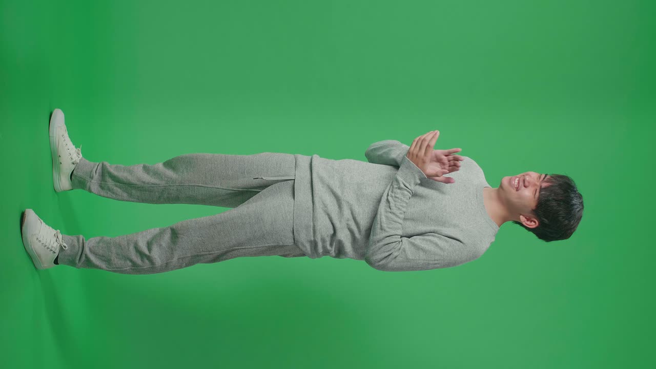 Full Body Of Side View Asian Man Clapping Her Hands In The Green Screen Studio