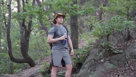 Male-Hiker-Drinking-Water-While-Taking-A-Break-In-Cheonggyesan-Mountain,-South-Korea---wide-shot