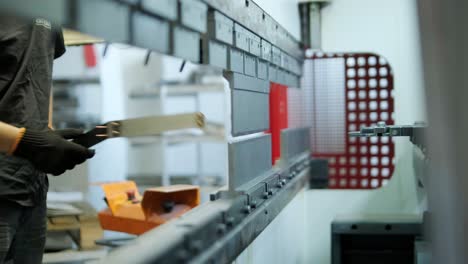 worker operating a press brake machine