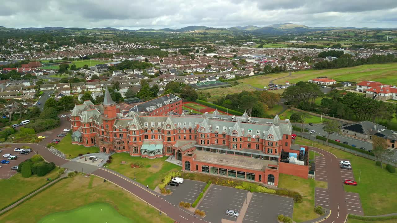 4K, 60FPS aerial video of the Slieve Donard Hotel in Newcastle, County Down in Northern Ireland. The camera passes from right to left