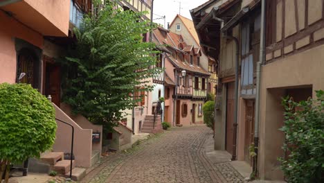 eguisheim has picturesque cobbled streets admiring colorful houses with pointed roofs and timber-framed facades which makes visitors feel like in a real-life fairytale