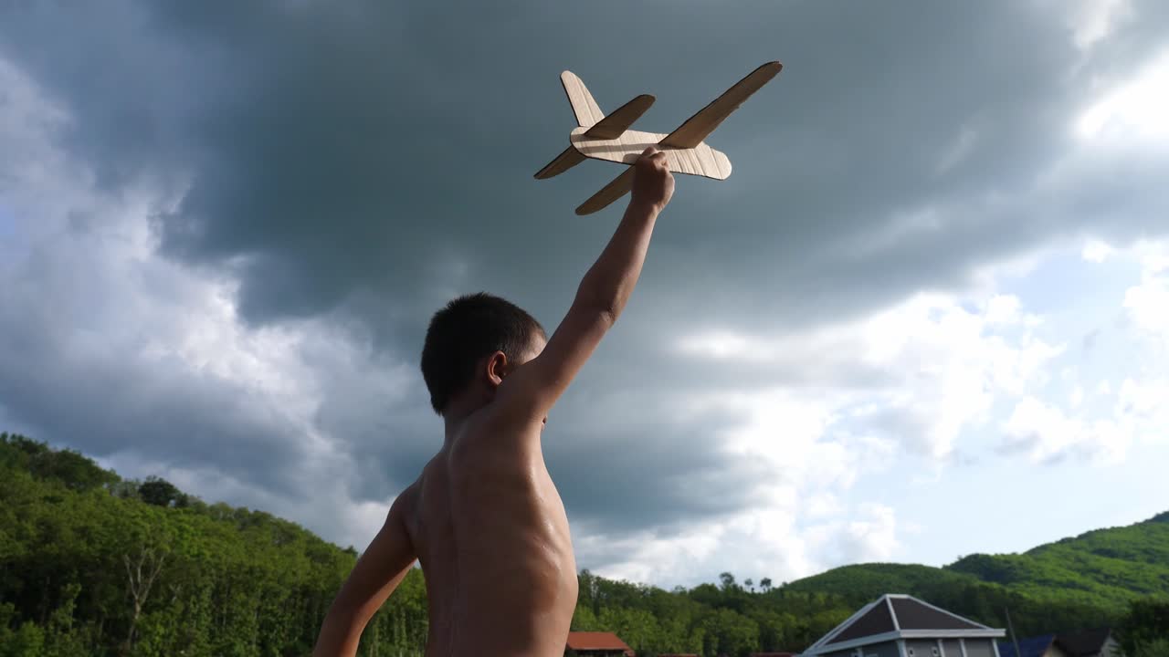 Boy playing with a toy airplane