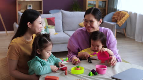 mothers and babies in living room