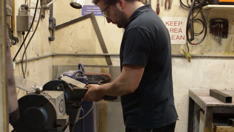 grinding steel on a bench grinder, manufacturing fabrication process