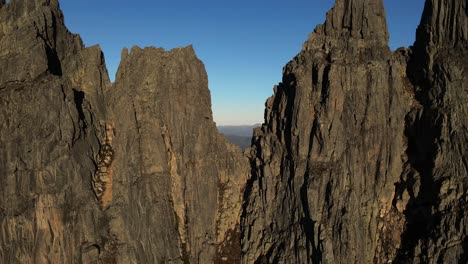 Aerial-view-showing-gigantic-Molladalen-Mountains-against-blue-sky-at-sunset-in-Norway