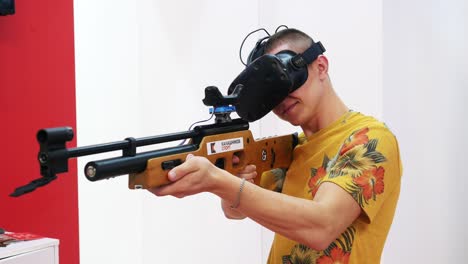 man using vr headset and shooting vr airsoft gun