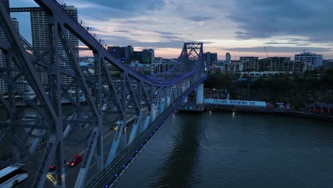 drone shot of story bridge, camera push in towards story bridge with brisbane cbd, river and howard smith wharves in background