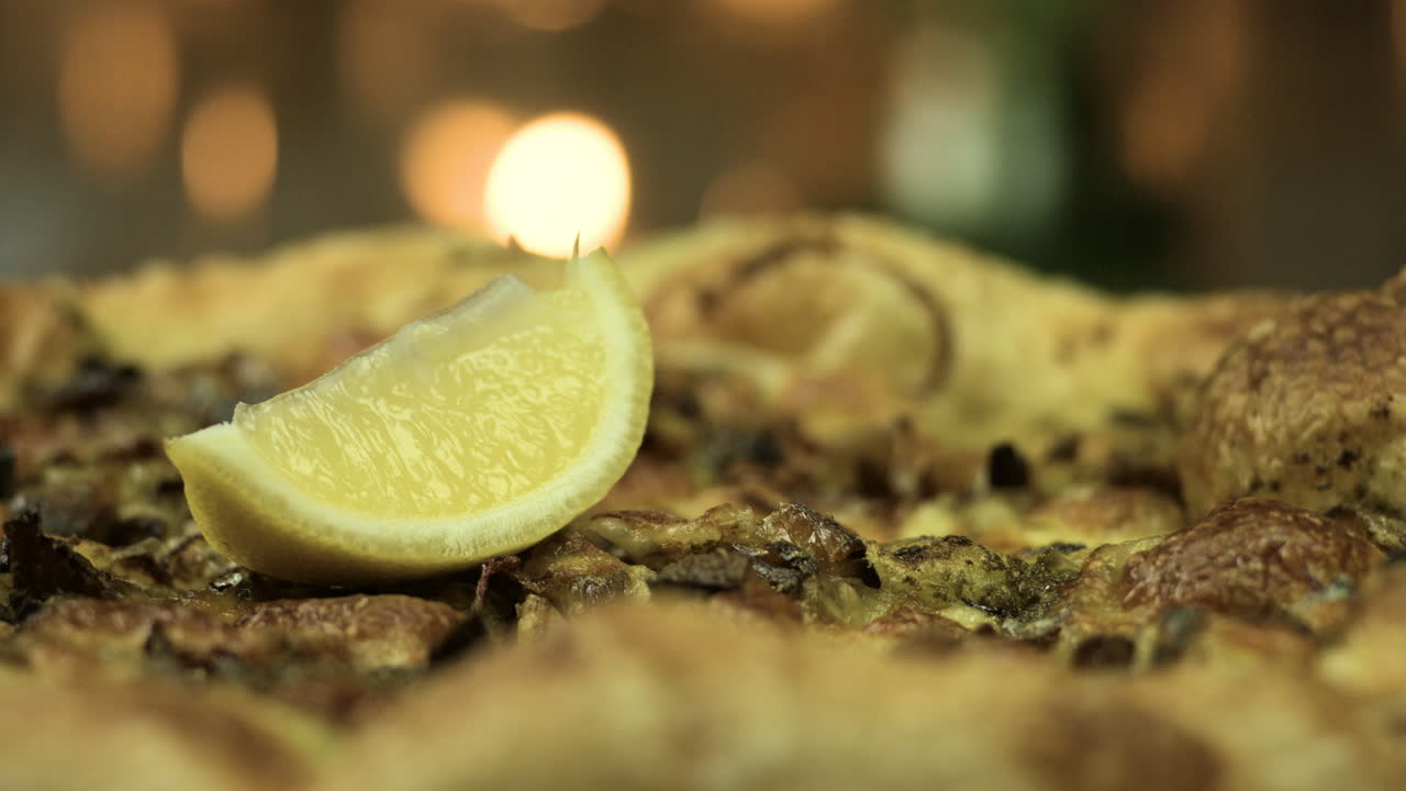 촛불 배경 4k로 갓 만든 레몬 피자 닫습니다