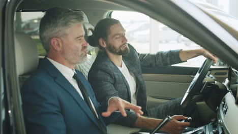 businessmen discussing a car purchase at a dealership