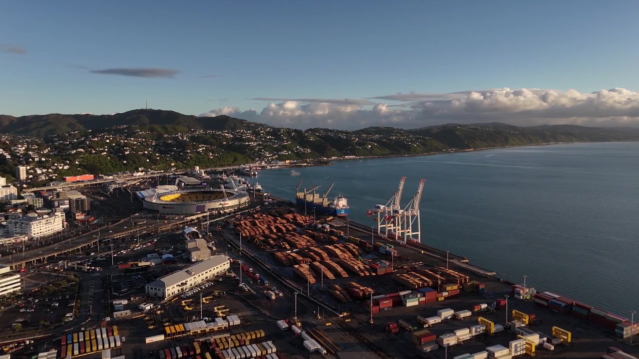 drone shot over the industrial shipping docks of CentrePort Wellingtonand Sky Stadium against the coastline.