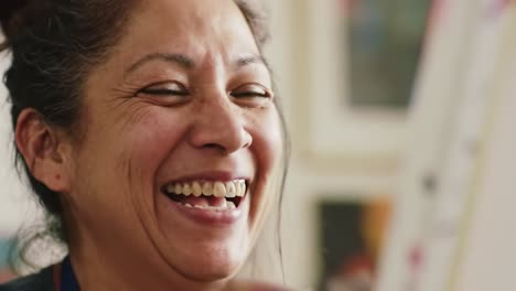 joyful artist enjoying the creative process with a paintbrush in hand, expressing happiness and passion for art during a vibrant painting session