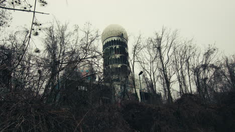 stealthily approaching an abandoned building through twigs and brambles