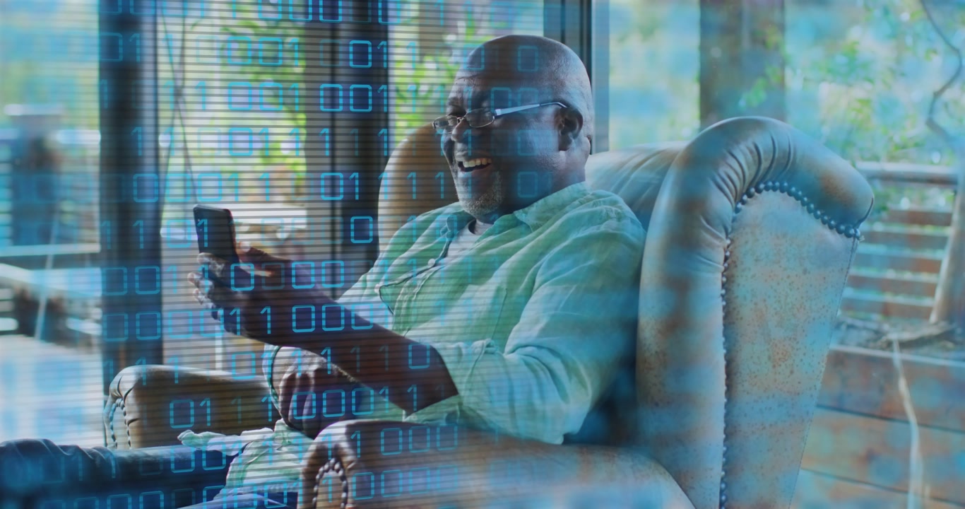 Man wearing glasses lifting smartphone and viewing data feed as binary overlay sparks laughter