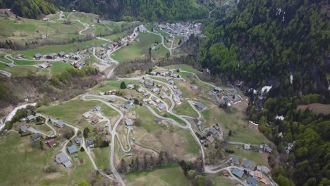 Aerial-view-over-peaceful-French-Alps-mountainside-village-in-summer