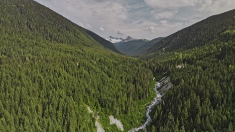 whistler bc canada aerial v7 flyover the creek capturing verdant valleys covered in dense coniferous forest, towering trees and gondola crossing mountain peaks - shot with mavic 3 pro cine - july 2023