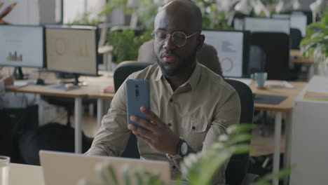 businessman looking at his smartphone in an office