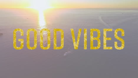 animation of the words good vibes written in yellow letters with sun setting over tranquil sea