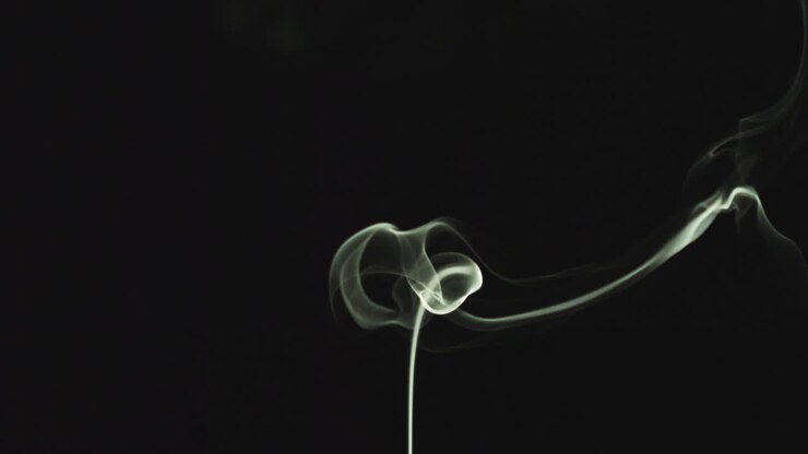 Close Up Of White Smoke From Candle Or Incense Drifting Across Frame Against Black Background 2