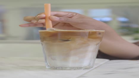 person enjoying an iced latte