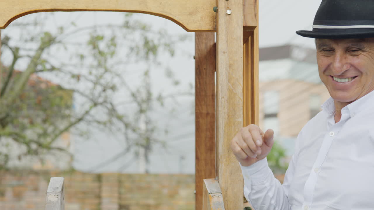 A tender moment in which a grandfather gives his grandson ice cream while they play together in a wooden playhouse with a slide in the backyard.