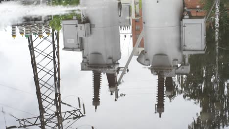 reflection of electrical transformers in a puddle