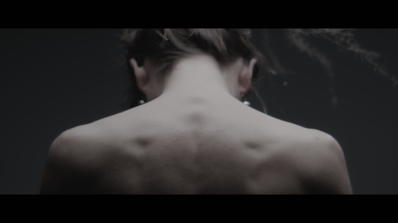 A woman dressed as mother nature shows her back