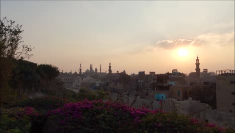 panoramic view over cairo cityscape during sunset, silhoette of mosque minarets in horizon, egypt