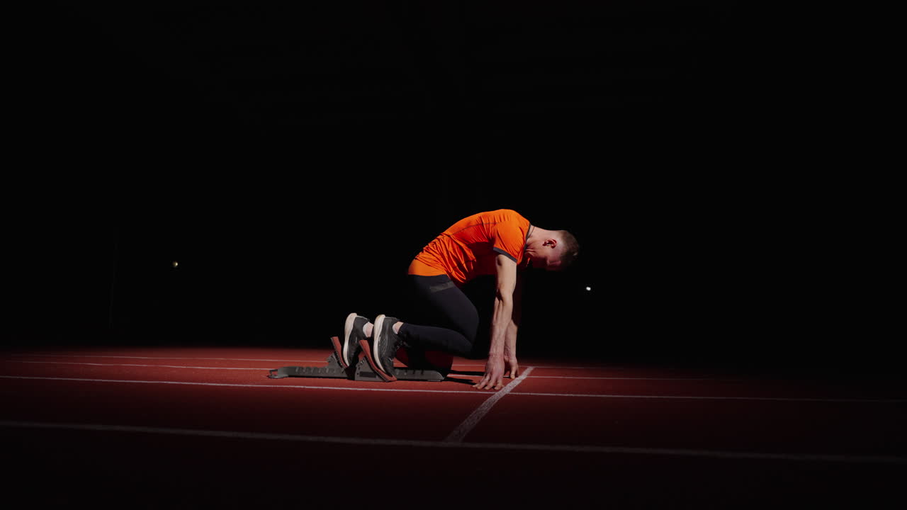 Athlete in starting block ready to sprint