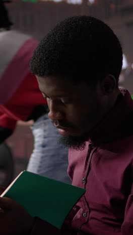 vertical video african american guy studies for a critical law exam and reading specialty books