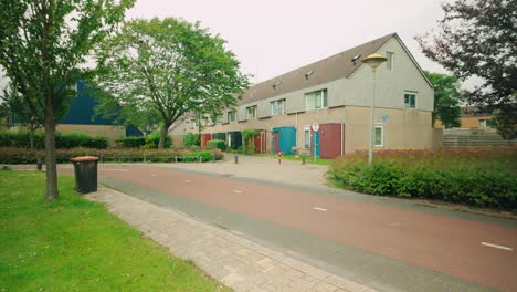 Footage-of-terraced-houses-in-Lelystad,-Flevoland,-surrounded-by-lush-greenery-during-spring