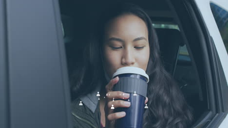 animation of media icons over biracial woman drinking coffee