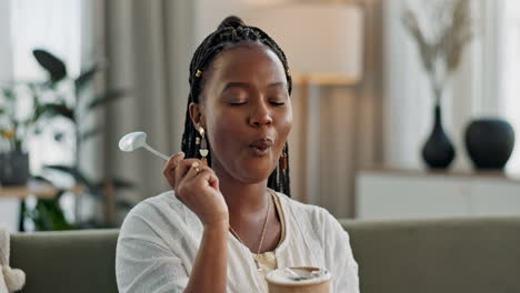 Black-woman-on-couch,-eating-ice-cream