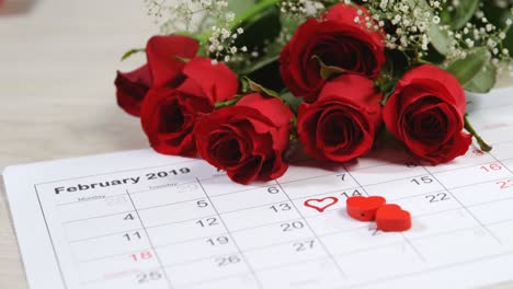 bouquet of red roses on the calendar showing 14th february 4k