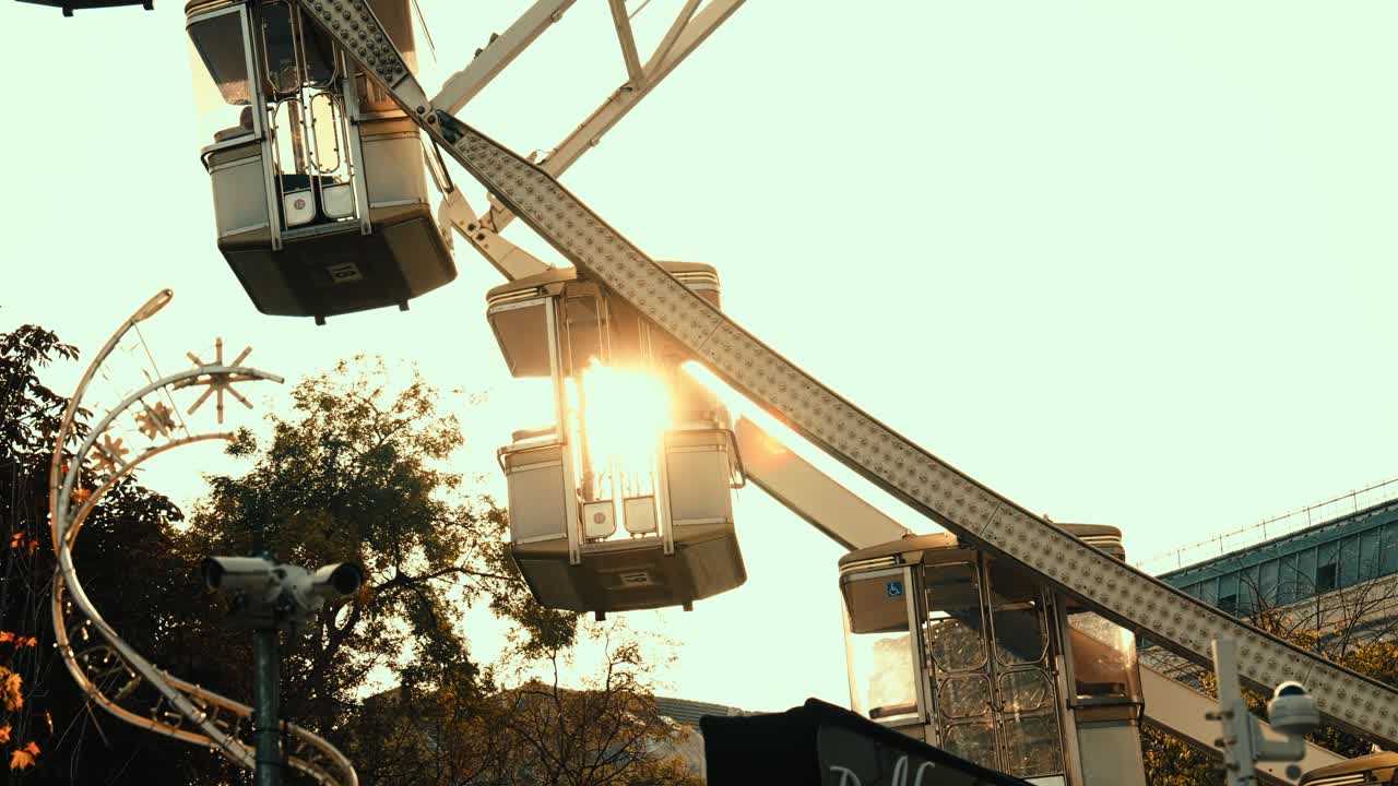 Ferris wheel in Budapest, Hungary, illuminated by warm evening sun. Autumn tones, cinematic lighting, peaceful atmosphere, and beautiful cityscape in the background